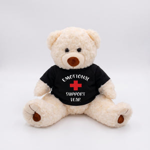 A white teddy bear wearing a black t-shirt with the text "Emotional Support Bear" printed on it.