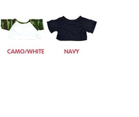 two t-shirts, one in camouflage and one in navy, with the text "CAMO/WHITE" and "NAVY" written above them.