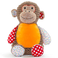 A stuffed toy monkey with a brown body, orange chest, and red and white polka dot accents.