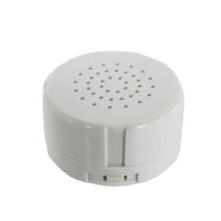 A white, circular speaker with a circular hole in the center.