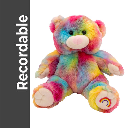 A colorful, tie-dye stuffed teddy bear with a rainbow pattern on its fur.