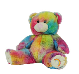 A colorful, tie-dye stuffed teddy bear with a rainbow pattern on its fur.