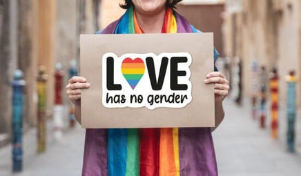 A person is holding a sign that says "LOVE has no gender".