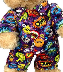 A teddy bear wearing a colorful, patterned outfit with various pop art-style speech bubbles and text.
