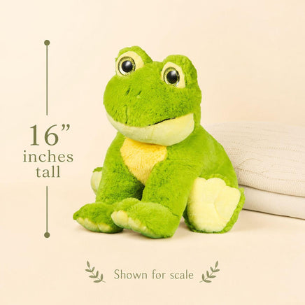A green plush frog toy is sitting on a beige surface, with a measurement scale indicating it is 16 inches tall.