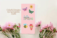 a pink card with colorful designs and illustrations, surrounded by pink flowers and a bee.
