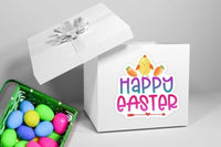a white gift box with a "Happy Easter" sticker on it, along with a green basket filled with colorful Easter eggs.