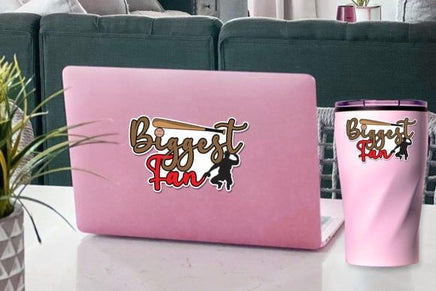 a pink laptop with a sticker on it, placed on a table next to a pink thermos.