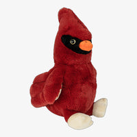 A red plush toy of a cardinal bird, with a black beak and feet, is sitting on a white background.