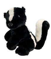 A black and white stuffed skunk toy is sitting on a white background.
