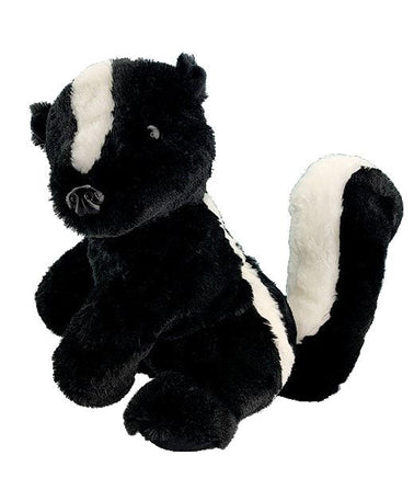 A black and white stuffed skunk toy is sitting on a white background.