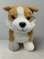 A stuffed dog toy with a brown and white color scheme and a black nose.