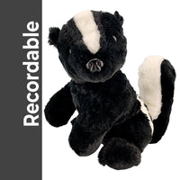 A plush toy of a black and white skunk is sitting on a white background.