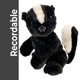 A plush toy of a black and white skunk is sitting on a white background.