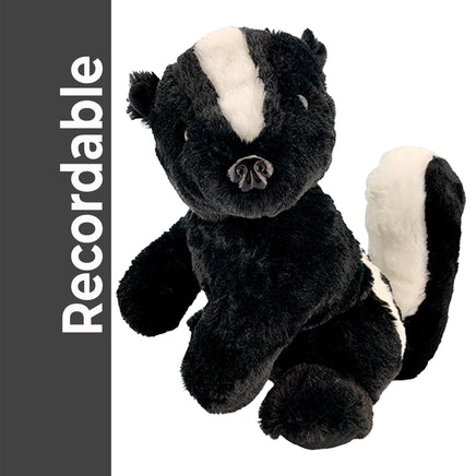 A plush toy of a black and white skunk is sitting on a white background.