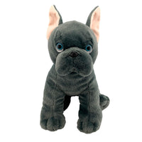 A plush toy of a black dog with large blue eyes and pink ears.