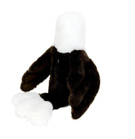 A stuffed toy eagle with a white head and brown body is sitting on a white background.