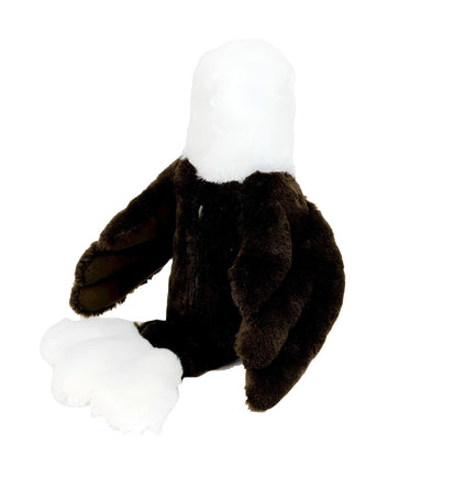 A stuffed toy eagle with a white head and brown body is sitting on a white background.