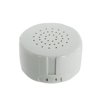A white, circular speaker with a circular pattern of holes on its surface.