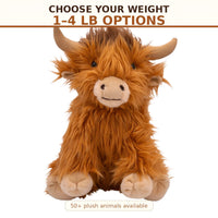 a large stuffed animal resembling a furry, horned creature with a smiling expression.