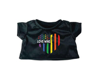A black t-shirt with a heart-shaped design featuring the text "LOVE WINS" and a rainbow flag pattern.