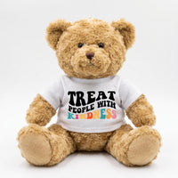 A brown teddy bear wearing a white t-shirt with the text "TREAT PEOPLE WITH KINDNESS" printed on it.