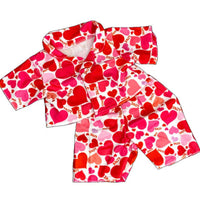 A pair of red pajama pants with a heart pattern, along with a matching red shirt.