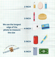 The image is a collage of various objects, including a 2-inch object, a 3-inch object, a 4-inch object, a 5-inch object, a 6-inch object, a pen, a can, a hamburger, a pencil, a crayon, a dollar bill, and a teddy bear. The objects are arranged in a grid-like pattern, and the image uses the longest edge of the photo to measure the size of the objects.