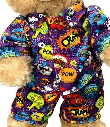 A teddy bear wearing a colorful, patterned outfit with various pop art-style speech bubbles and text.