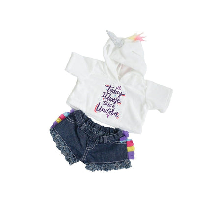 A white hoodie with a unicorn design, denim shorts with frayed edges, and a unicorn headband are displayed against a white background.