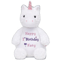 A white stuffed unicorn toy with a pink horn and a personalized birthday message on its belly.