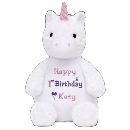 A white stuffed unicorn toy with a pink horn and a personalized birthday message on its belly.