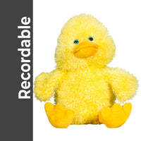 A yellow stuffed duck toy is sitting on a white background.