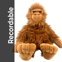 A brown plush toy of a large primate, possibly a gorilla or an orangutan, sitting on a white background.