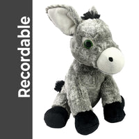 A gray stuffed donkey toy with black accents and a white nose is sitting on a white background.