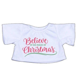 A white t-shirt with the text "Believe in the Magic of Christmas" printed on it in red and green lettering.