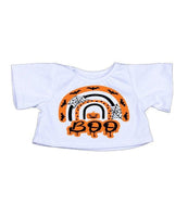A white t-shirt with a Halloween-themed graphic design featuring a rainbow, bats, and the word "BOO" in orange and black.