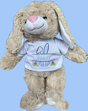 A stuffed toy bunny wearing a white t-shirt with the name "Baker" printed on it.