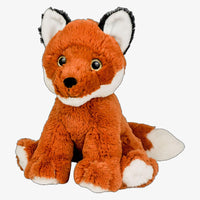 A stuffed toy fox sitting on the ground.