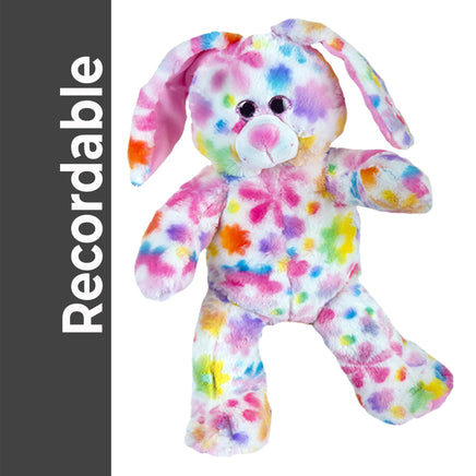 A colorful, multicolored stuffed rabbit toy is shown against a white background.