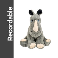 A plush toy rhinoceros with a gray and white color scheme and large, expressive eyes sits on a white background.