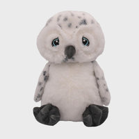 A plush toy of a white owl with blue eyes and gray markings on its body and legs.