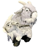 Two stuffed toy goats, one standing upright and the other sitting, are the main subjects of the image.