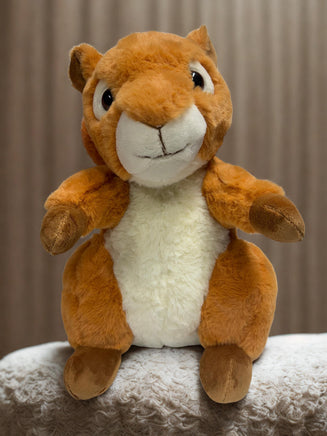 A stuffed toy squirrel sitting on a surface.