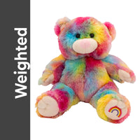 A colorful, tie-dye stuffed teddy bear is shown against a white background.
