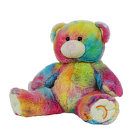 A colorful, tie-dye stuffed teddy bear with a rainbow pattern on its fur.