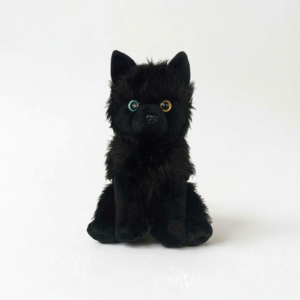 A black plush toy dog with large, expressive eyes sits on a white background.