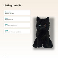 a black stuffed animal dog with teal and gold eyes, sitting on its hind legs.