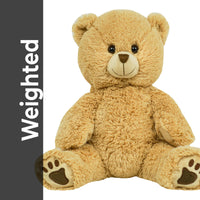 A large, light brown teddy bear sitting on its hind legs with its front paws resting on the ground.