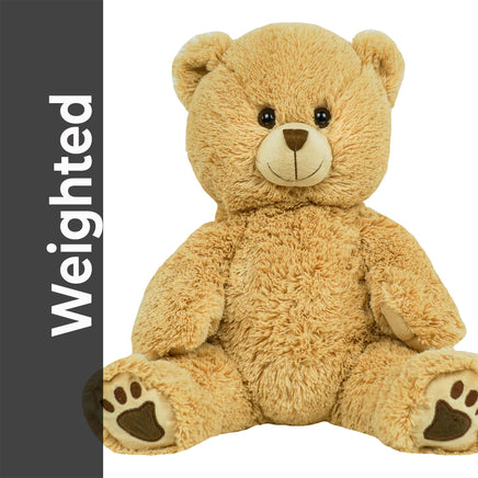 A large, light brown teddy bear sitting on its hind legs with its front paws resting on the ground.
